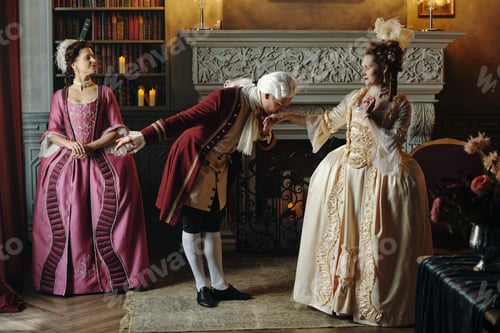 Preview: Caucasian Young Man Bowing and Kissing Hand of Woman in Baroque Costume