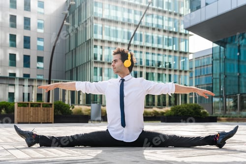 Preview: Flexible and cool businessman doing acrobatic trick
