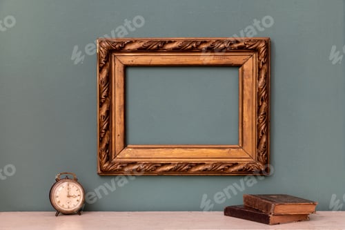 Preview: Empty gold vintage picture frame with books