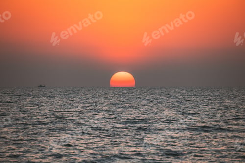 Preview: Sundown Above Sea Horizon At Sunset. Natural Sunrise Sky Warm Colors Over Ocean