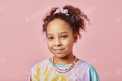 Preview: Cute smiling African American girl in t-shirt and necklace looking at camera