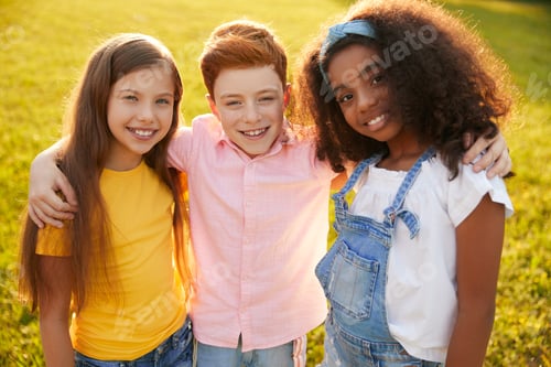 Preview: Company of diverse kids hugging in park