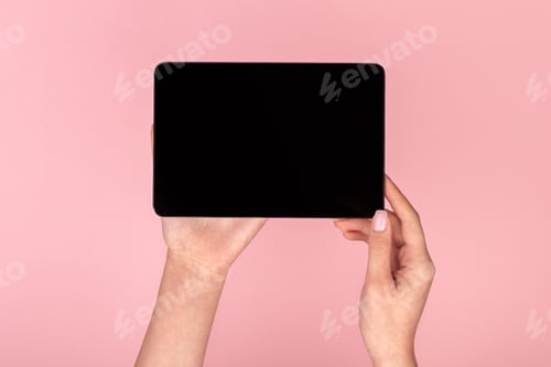 Preview: Woman using black tablet on pink background
