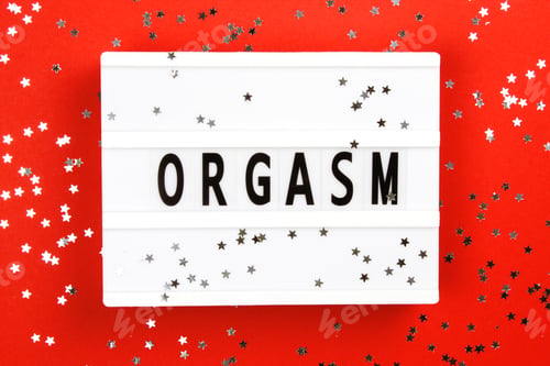 Preview: Photo of a light box with text orgasm on red background