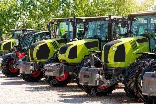 Preview: Row of tractors displayed at outdoor farm machinery dealership