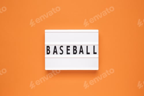 Preview: The word baseball on lightbox isolated orange background.