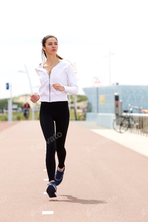 Preview: Young woman runner on path outside