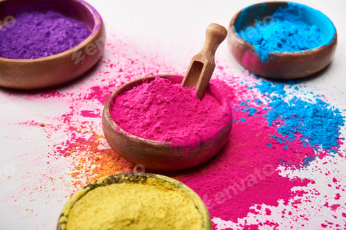 Preview: wooden spatula and bowls with yellow, pink, blue and purple holi powder on white background