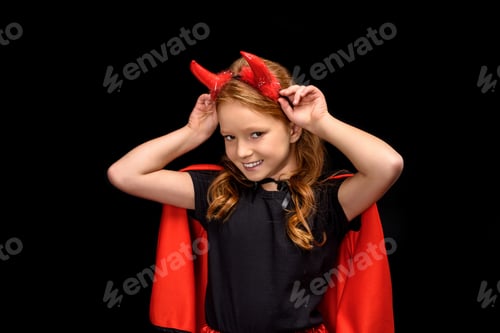 Preview: child in halloween costume of devil, isolated on black