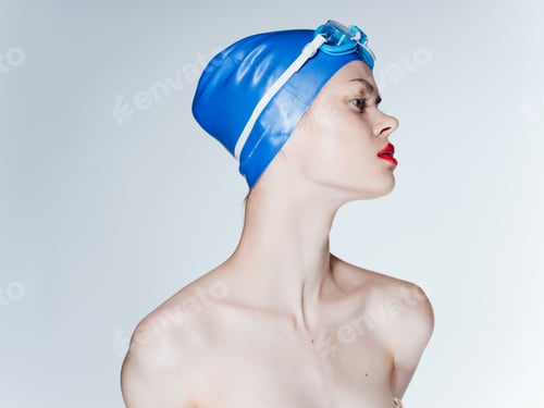 Preview: Portrait of a woman swimmer on a light background, naked shoulders and red lips