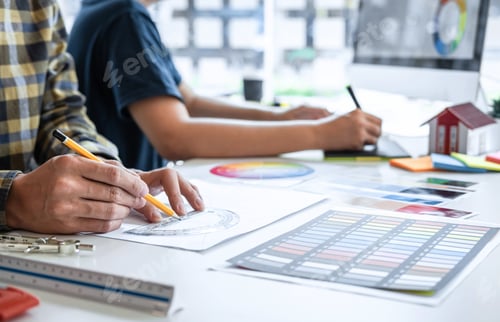 Preview: Team of young Interior graphic designer working sketching on graphic tablet and color swatch