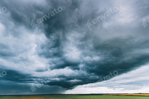 Preview: Summer Rainy Sunset Evening Above Rural Field Landscape. Scenic Dramatic Sky With Rain Clouds