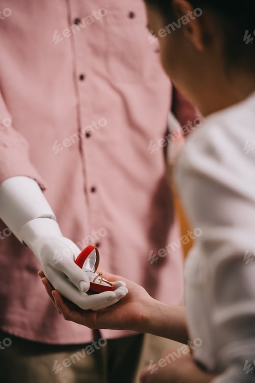 Preview: woman and mannikin with jewelry box in hand, perfect relationship and marriage dream concept