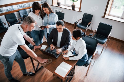 Preview: Aerial view. Business people and manager working on their new project in classroom