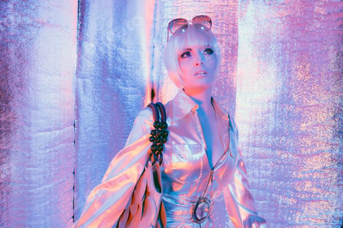 Preview: Space Fashion Woman Wearing Jump Suit And Bag. Standing In Reflective Solar Room.