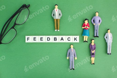 Preview: miniature people and glasses with the word feedback or response.