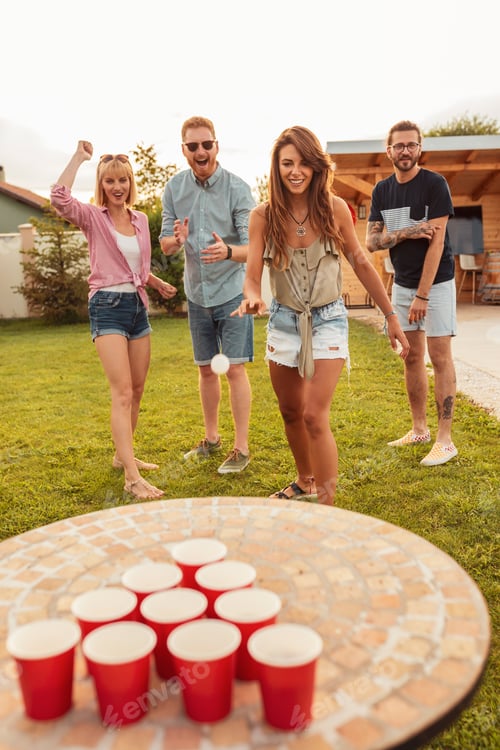 Preview: Friends having fun playing beer pong