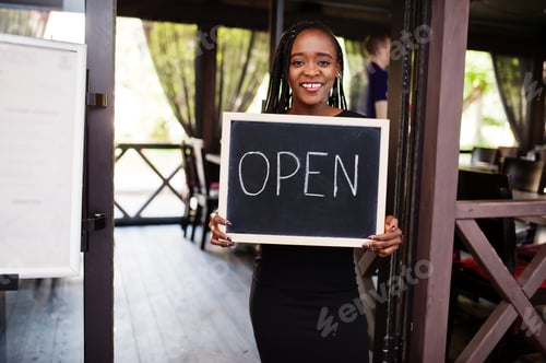 Preview: African american woman hold open welcome sign board
