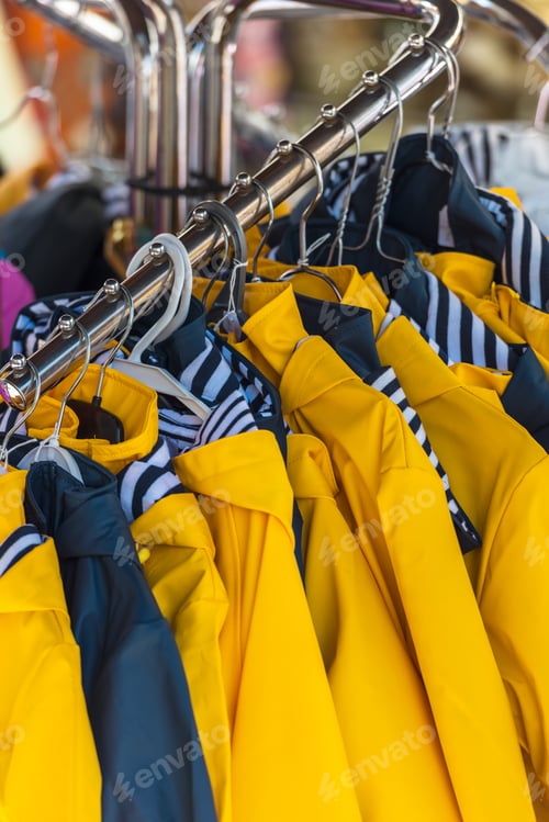 Preview: Bright raincoats hanging at a fashion store