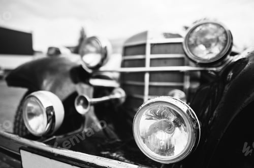 Preview: Old vintage car headlight close up. Black and white photo