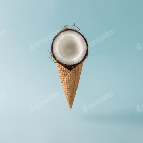Preview: Coconut with ice cream cone on pastel blue background. Foos creative concept.