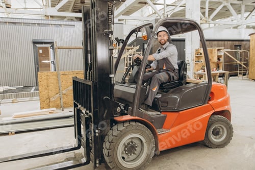 Preview: Construction worker driving forklift in modular building factory