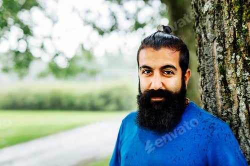 Preview: Man looking at camera in park