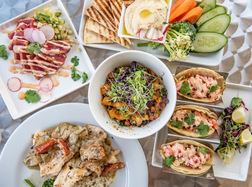 Preview: A variety of freshly made apps and entrees shot from overhead.