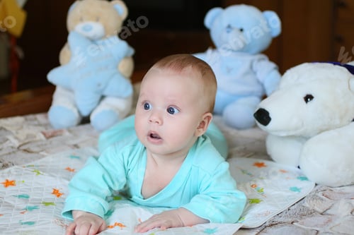 Preview: Funny infant with his toys around.