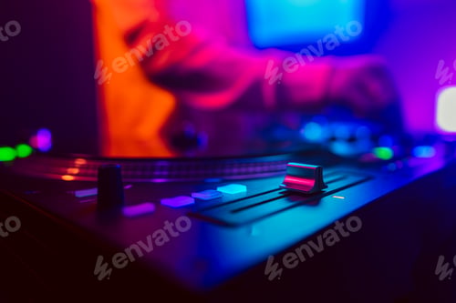 Preview: Hands of a DJ creating and regulating music on dj console mixer at club concert