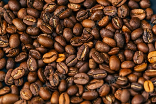 Preview: close-up on black-blue background lie roasted coffee beans laid out in the shape of a heart
