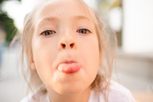 Preview: Funny kid girl showing tongue