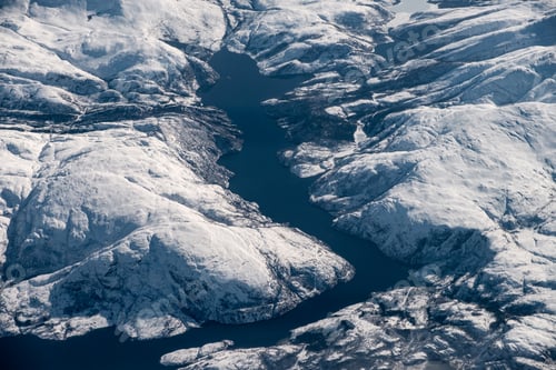 Preview: Aerial view of snowy mountain range with lake on winter