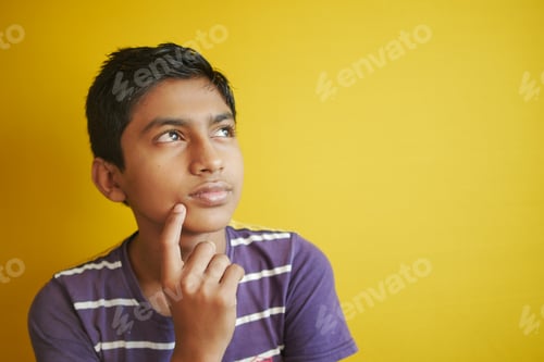Preview: thoughtful boy looking away while sited