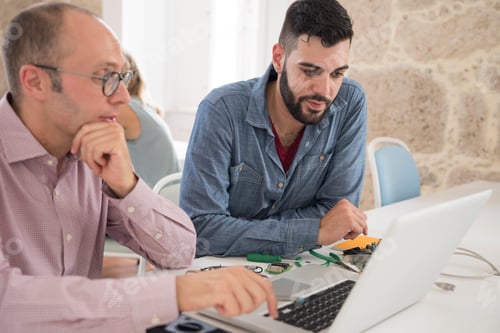 Preview: Computer technician repairing businessman's laptop on office desk