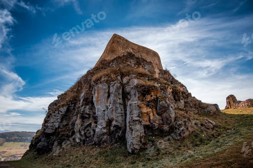 Preview: Beautiful view of an ancient fortress on a rock under a blue partially cloudy sky.