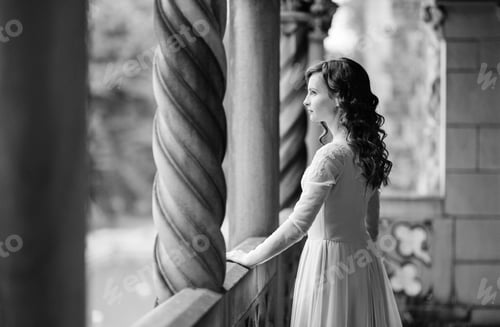 Preview: A girl in a light pink dress against the background of a medieva castle