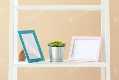 Preview: White bookshelf with plant in pot against beige background