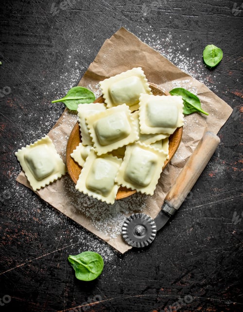 Preview: Raw Ravioli in a bowl on paper.