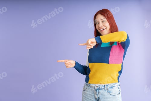 Preview: Young red-haired woman pointing to the side