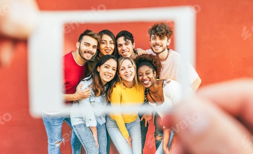 Preview: Happy multiracial friends taking a photo with istant camera paper style