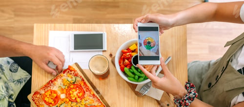 Preview: Banner of unrecognizable young girl blogger taking video of poke bowl with smartphone in cafe
