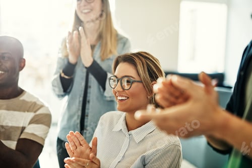 Preview: Smiling group of diverse colleagues clapping during an office meeting