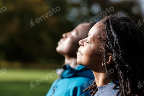 Preview: Portrait of two mature black women enjoying sun in an autumn day.
