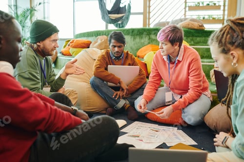 Preview: Group of young intercultural financial managers in casualwear discussing papers