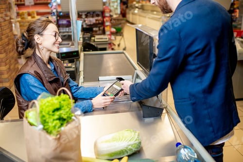 Preview: Paying with card at the cash register with happy cashier