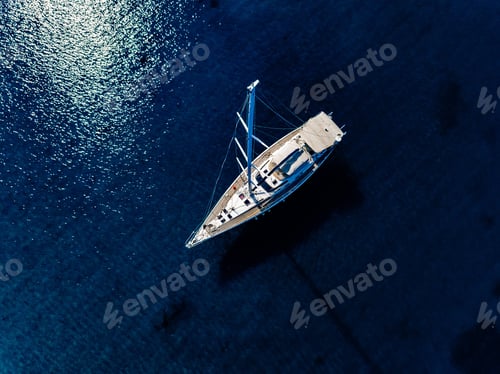 Preview: Aerial birds eye view from drone of yacht in deep blue sea