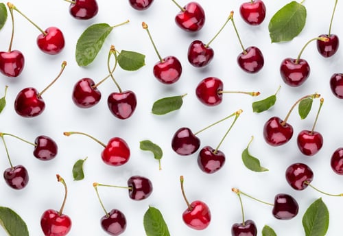 Preview: Cherry berries on a pastel background top view. Background with a cherry on a sprig, flat lay