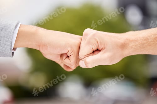 Preview: Shot of two unrecognizable businesspeople giving each other a fist bump in the city