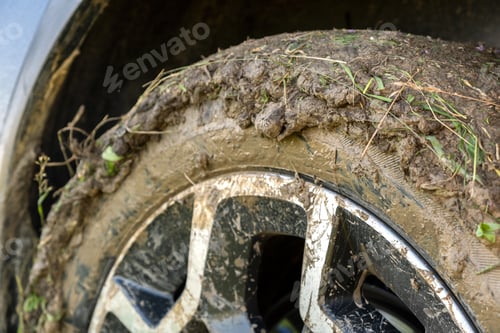 Preview: Close up of dirty off road car wheels with dirty tires covered with yellow mud